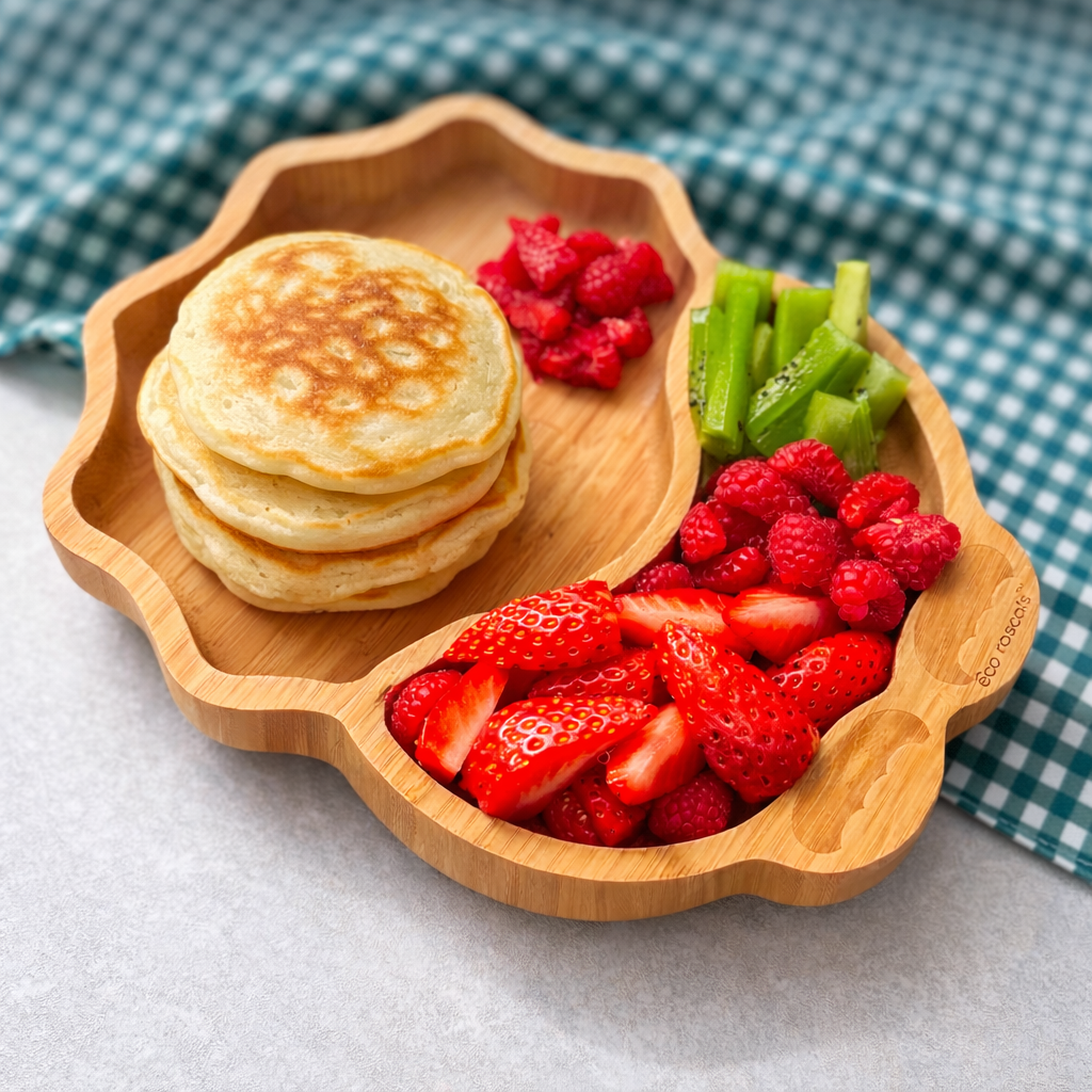 Kiwi pancakes with strawberries and raspberries on a bamboo toddler plate